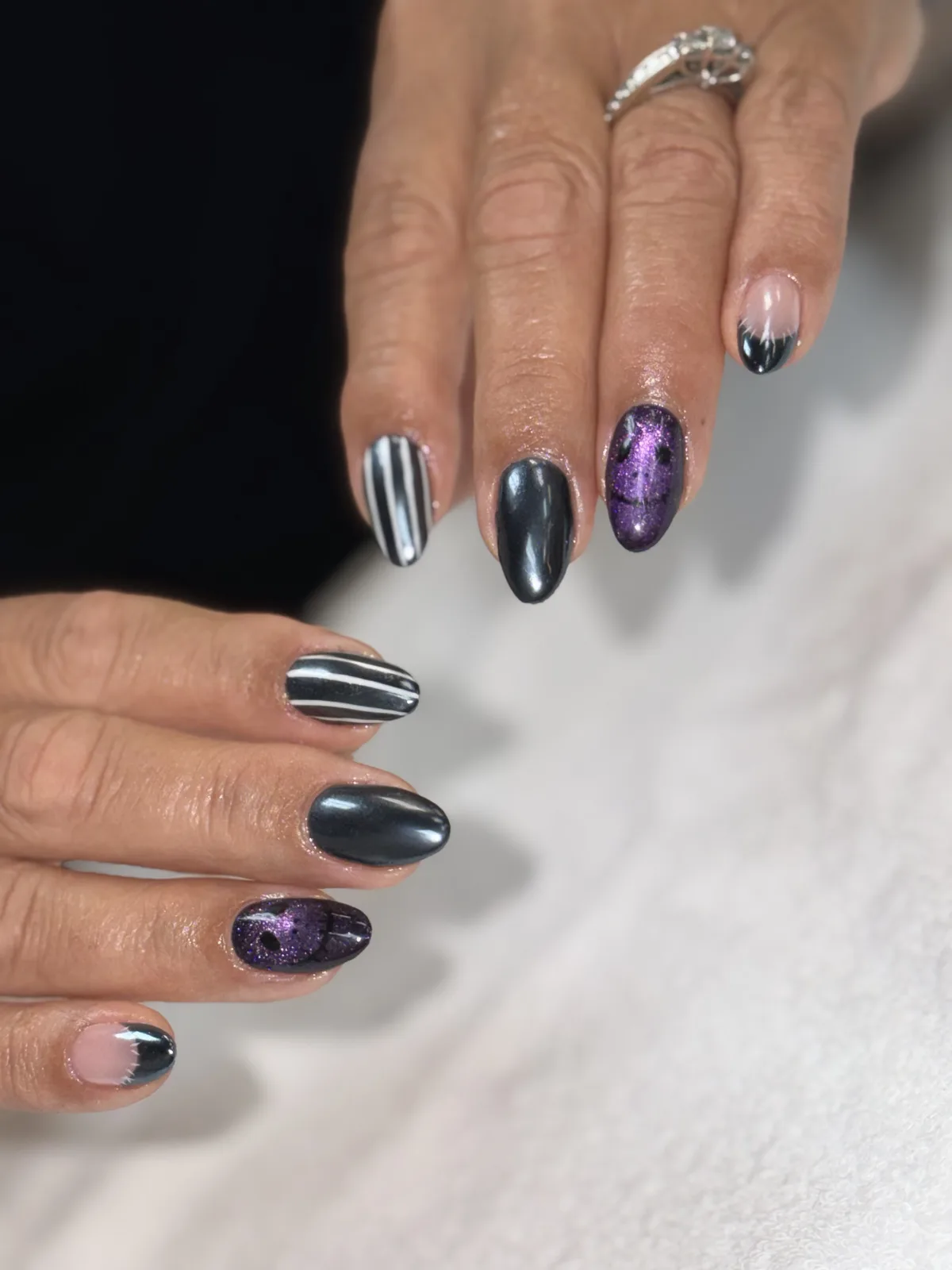 Gunmetal chrome, striped and purple cat-eye Halloween nails, second angle, at G Salon & Spa in Port St. Lucie, FL