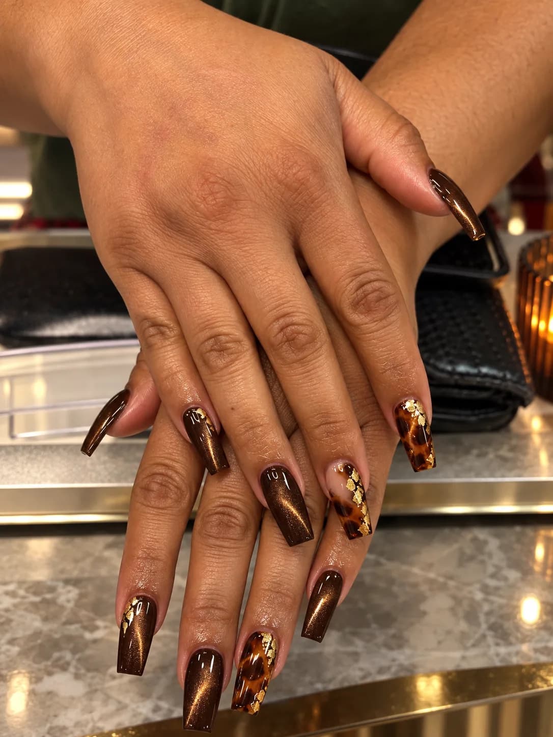 Mocha brown coffin nails with amber tortoiseshell accents and gold leaf at G Salon & Spa in Port St. Lucie, FL