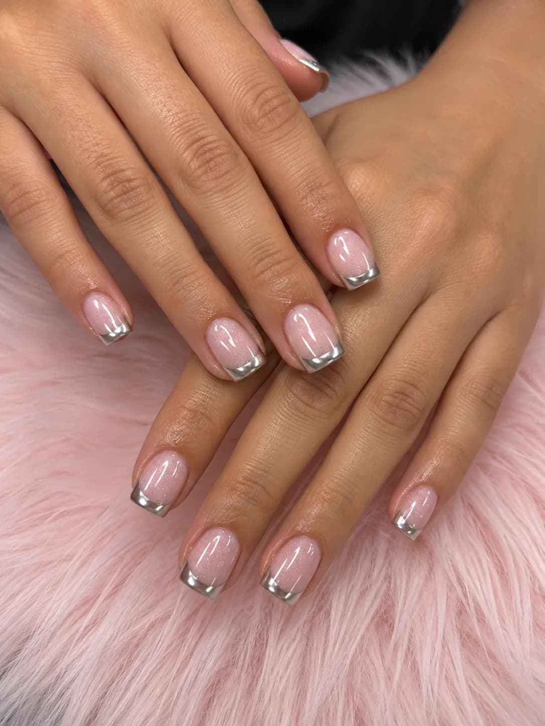 Short square nails in sheer shimmering pink with mirror silver chrome French tips at G Salon & Spa in Port St. Lucie, FL