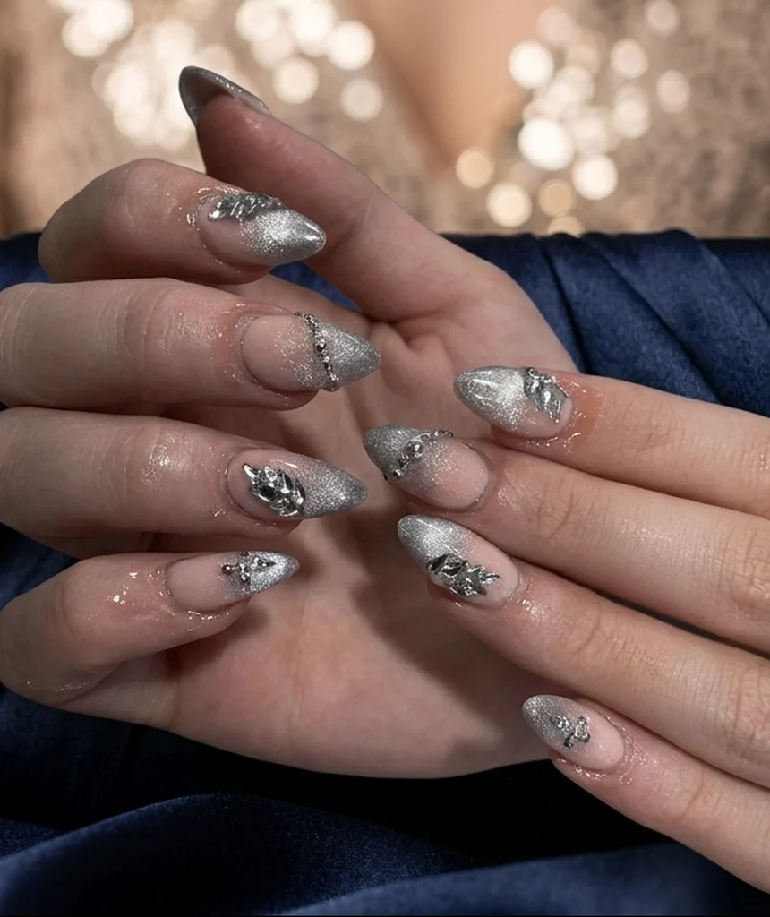 Inspired by a real G Salon set: silver chrome almond nails with silver gems on a navy satin clutch, sequin dress lights behind