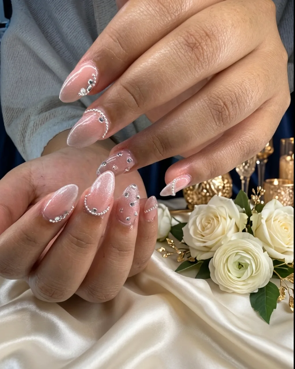 Inspired by a real G Salon set: pearly glazed almond nails with lines of tiny pearls and crystals beside white flowers
