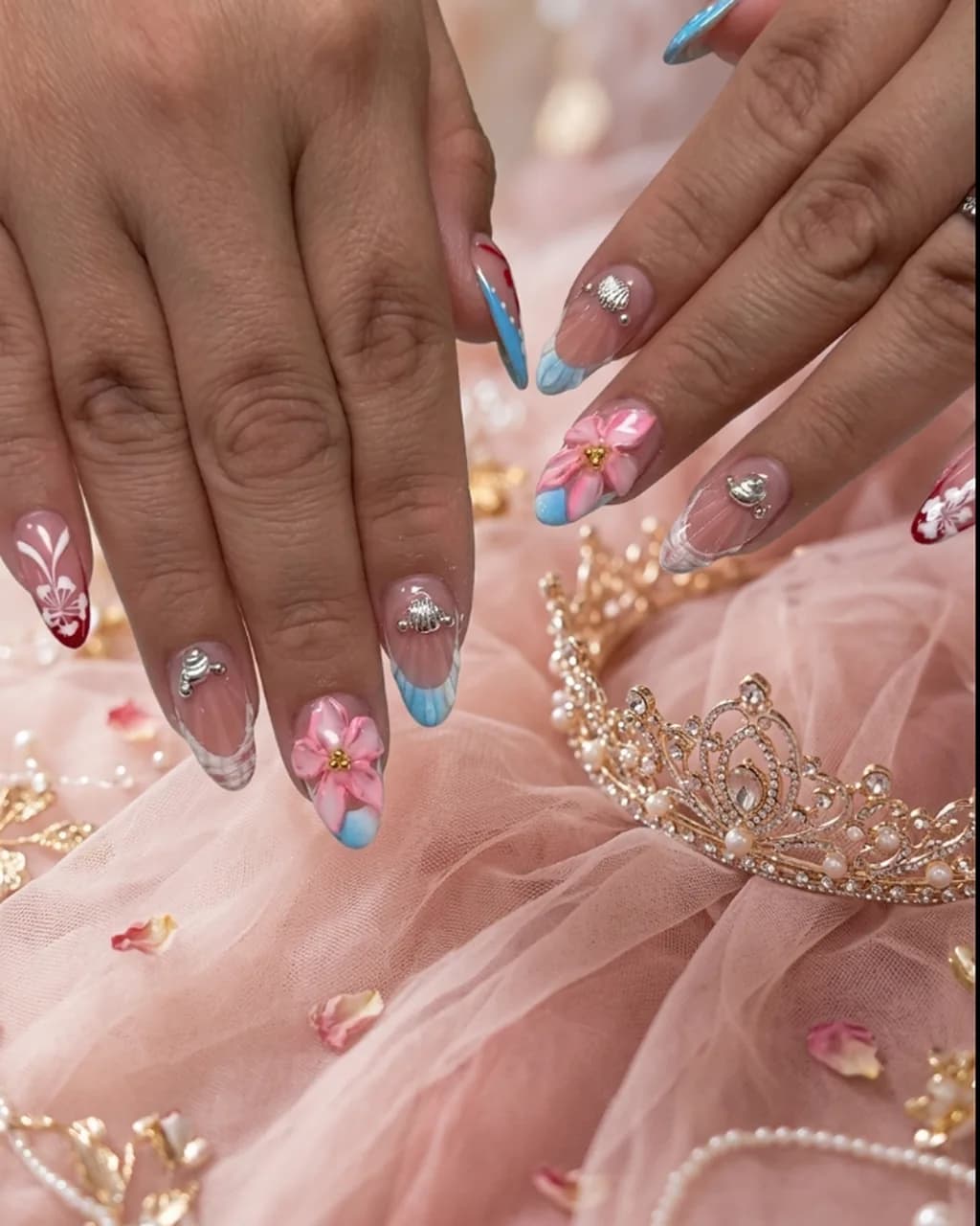 Inspired by a real G Salon set: raised pink 3D flowers and crystals on a blue-and-pink French beside a tiara