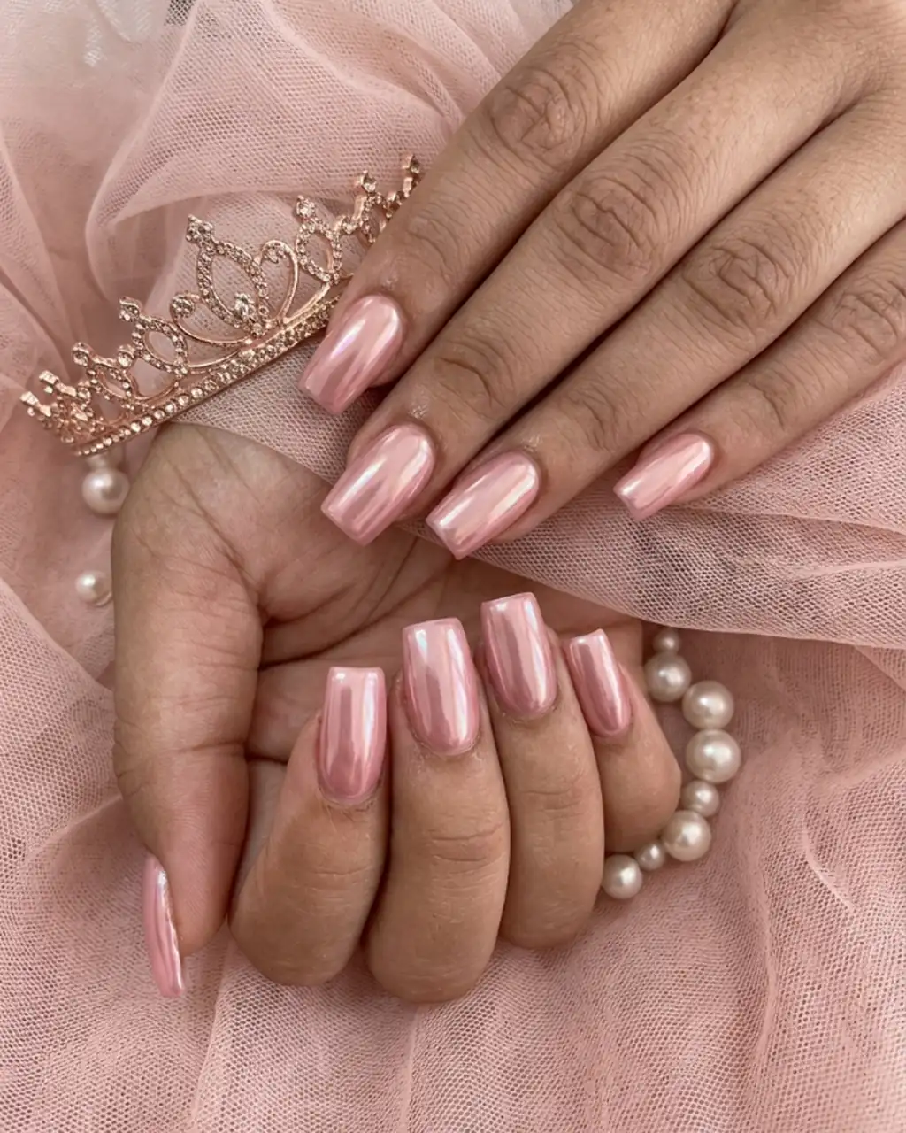 Inspired by a real G Salon set: almond nails in rose-gold chrome resting on blush tulle