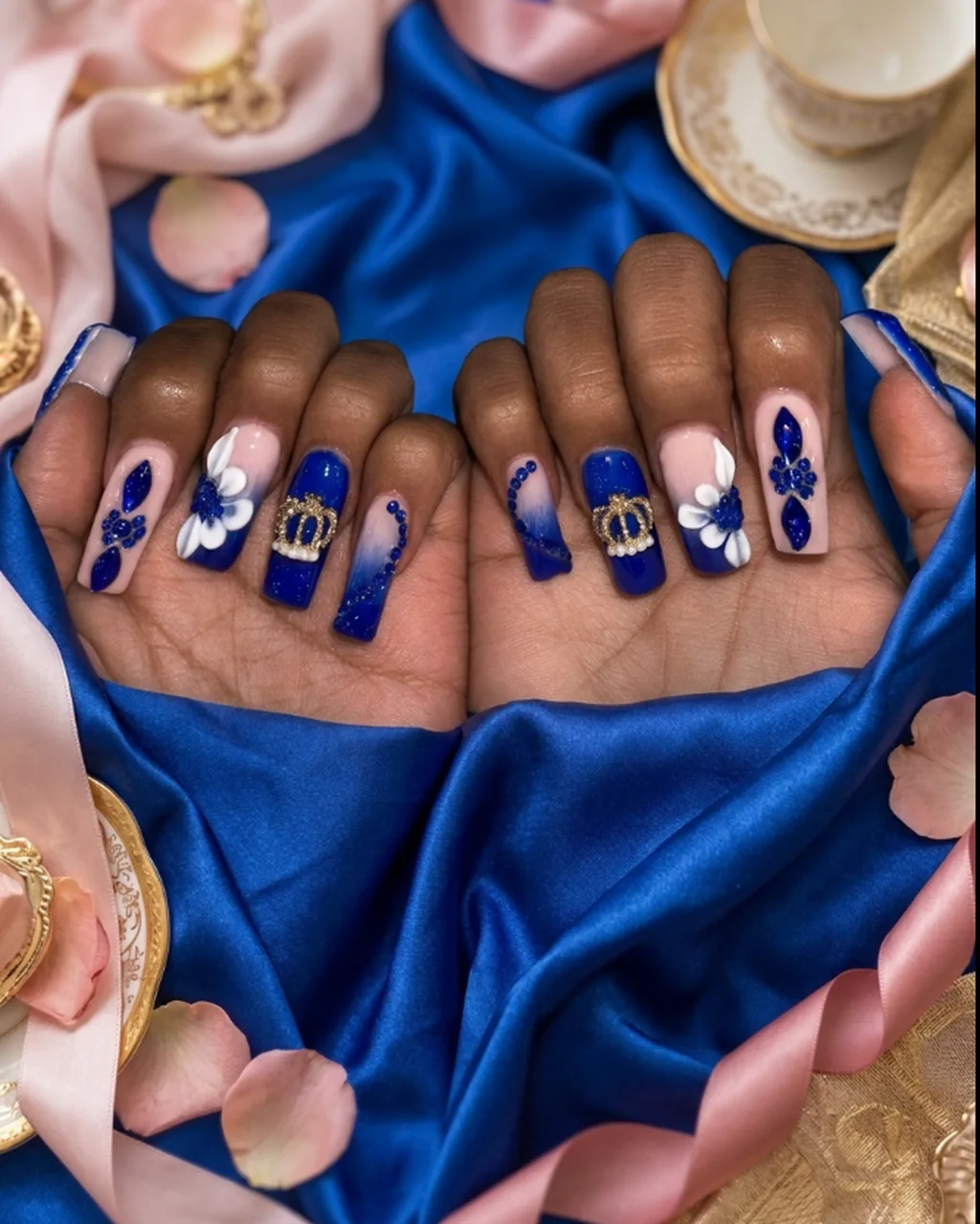 Inspired by a real G Salon set: royal blue ombre nails with a gold crown charm and crystals on royal blue satin