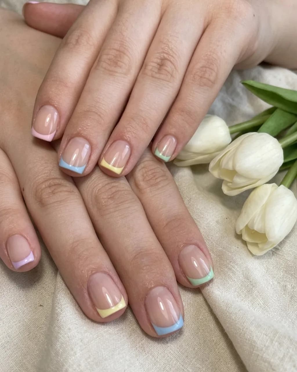Inspired by a real G Salon set: almond nails with a different pastel French tip on each finger