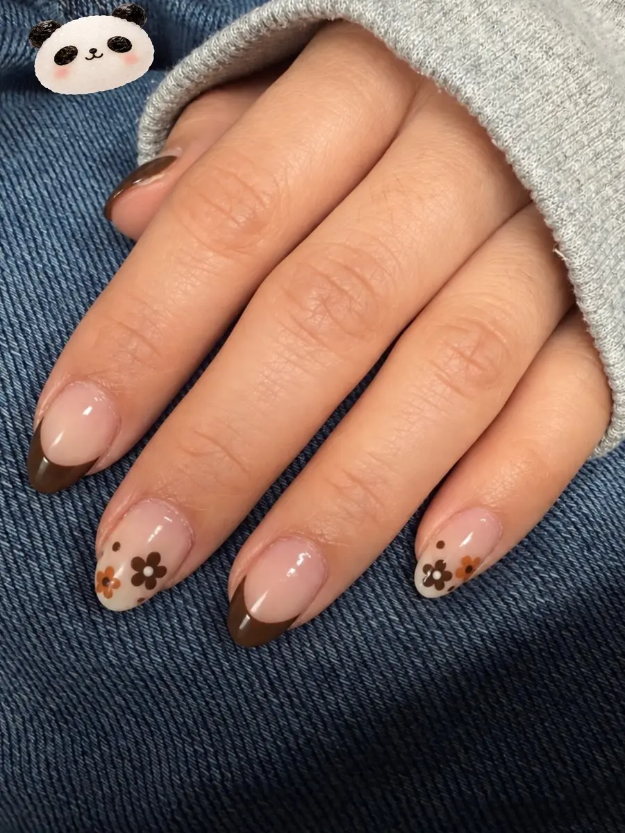 Real set from G Salon & Spa: brown French tips with a daisy accent