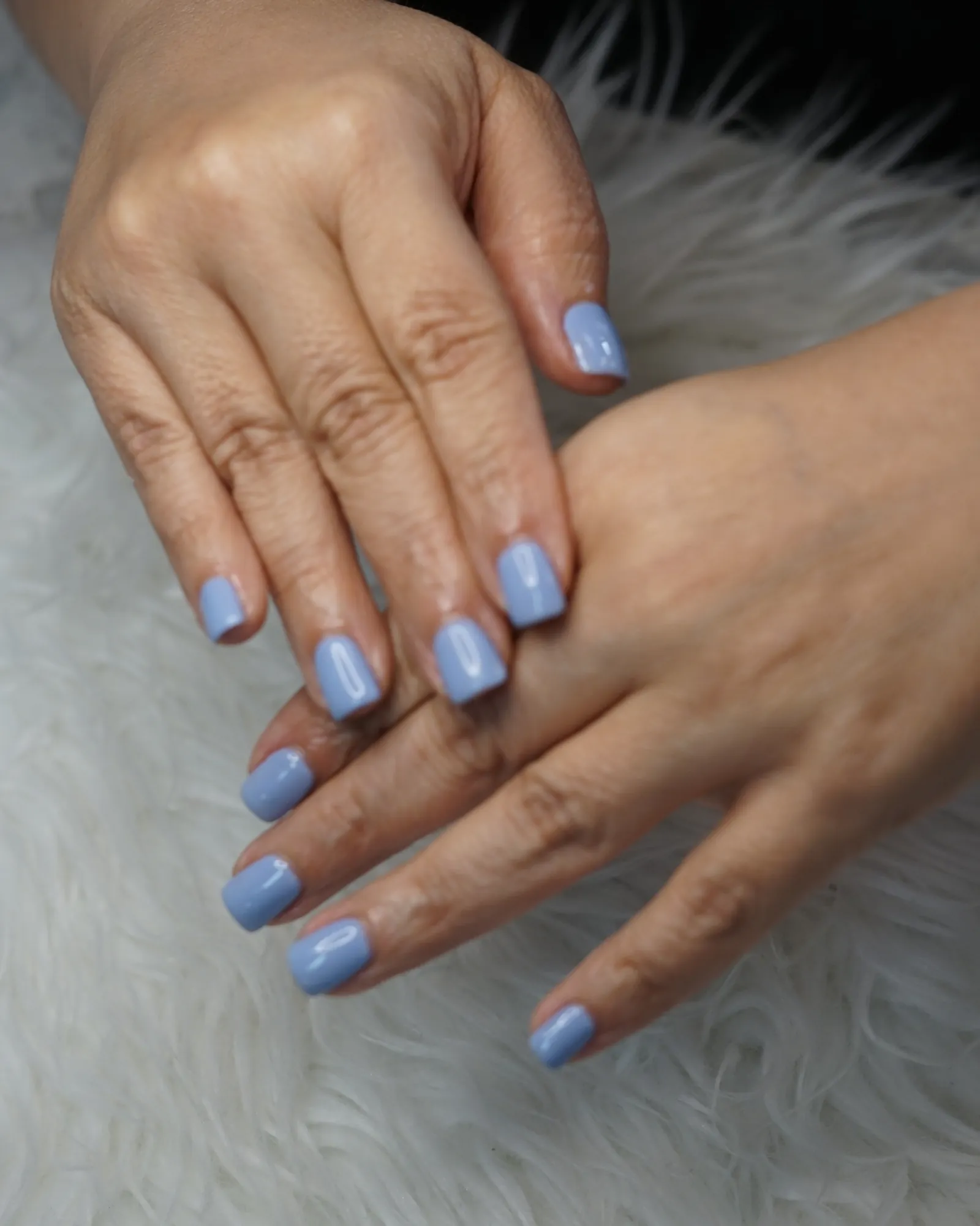 Short square nails in a soft blue gel polish, a real gel manicure done at G Salon & Spa in Port St. Lucie