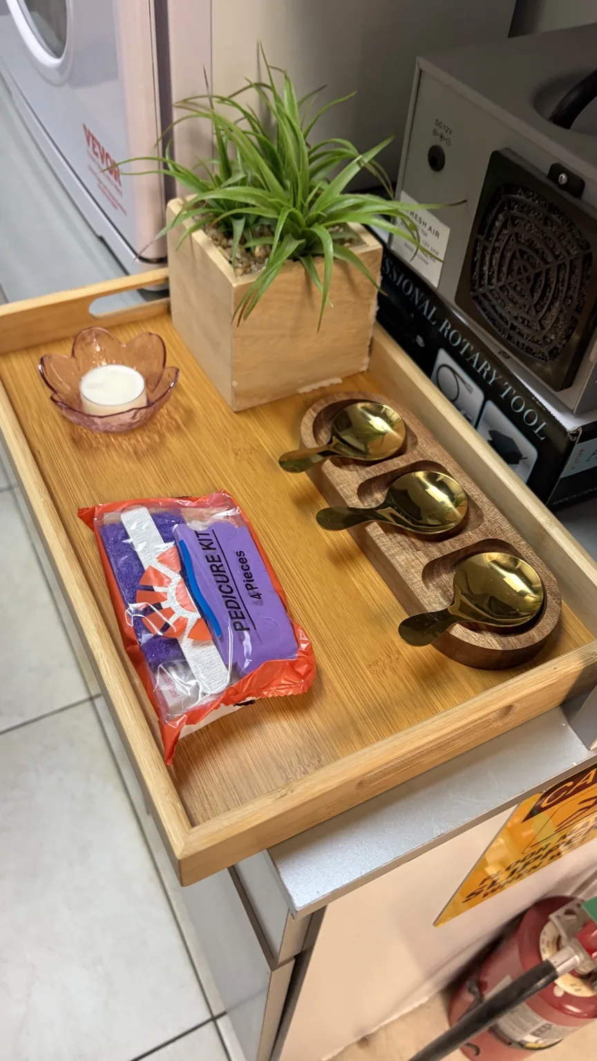 Pedicure tray set with gold bowls, a candle and a small plant