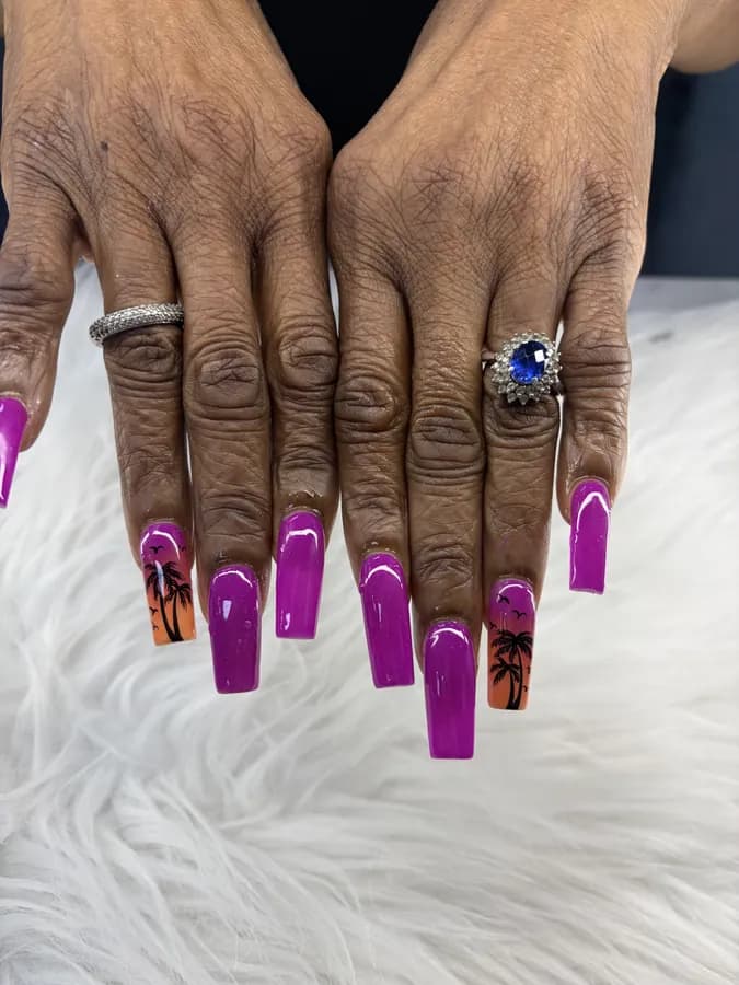 Long purple coffin nails with palm trees painted over a sunset on two accents