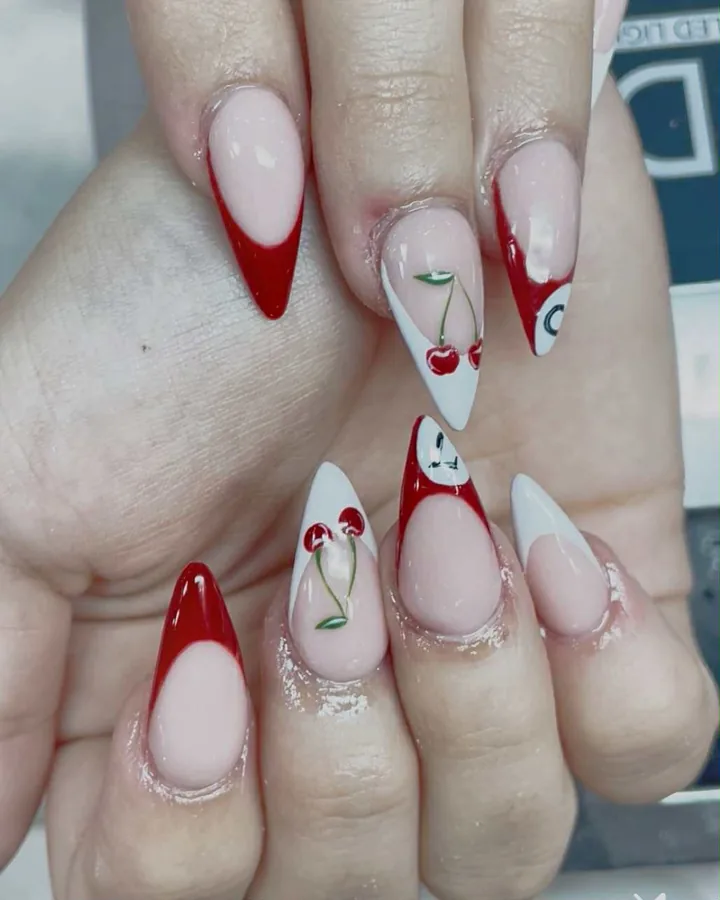 Red French stilettos with hand-painted cherries on white accent nails