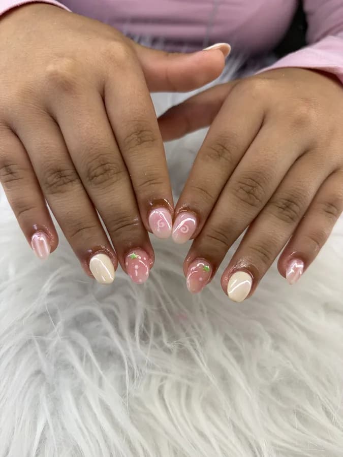 Short almond nails in sheer pink and cream with white swirl accents